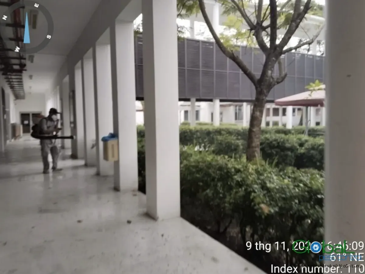 A technician treating the corridor of an apartment building