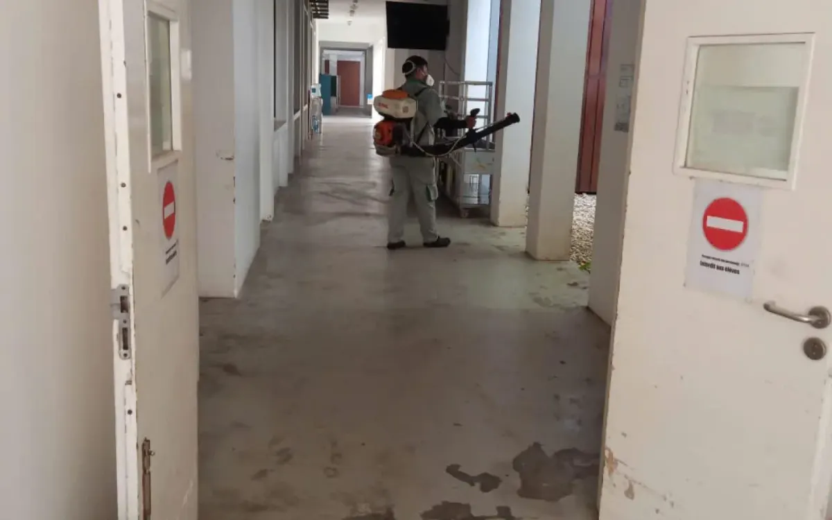 A technician checking and treating a corridor in a medical facility
