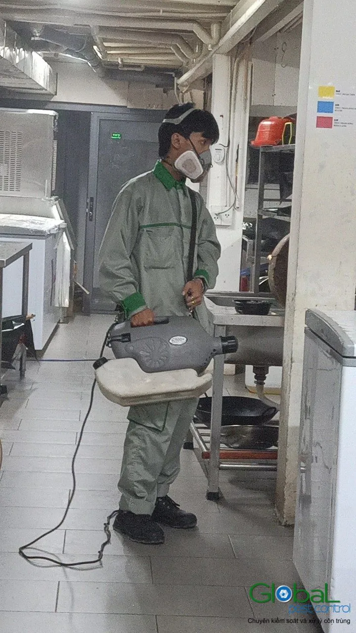 A technician cold-fogging a kitchen