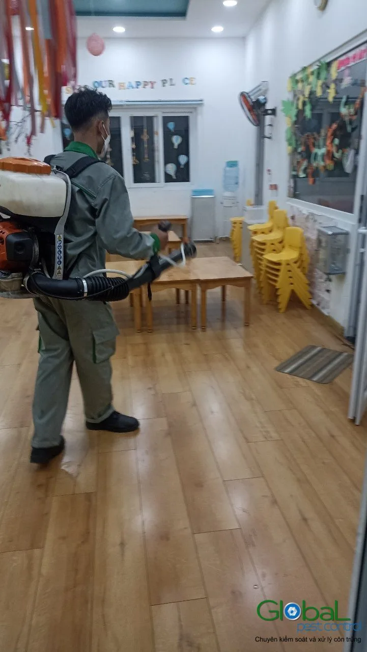 A technician treating a kindergarten classroom