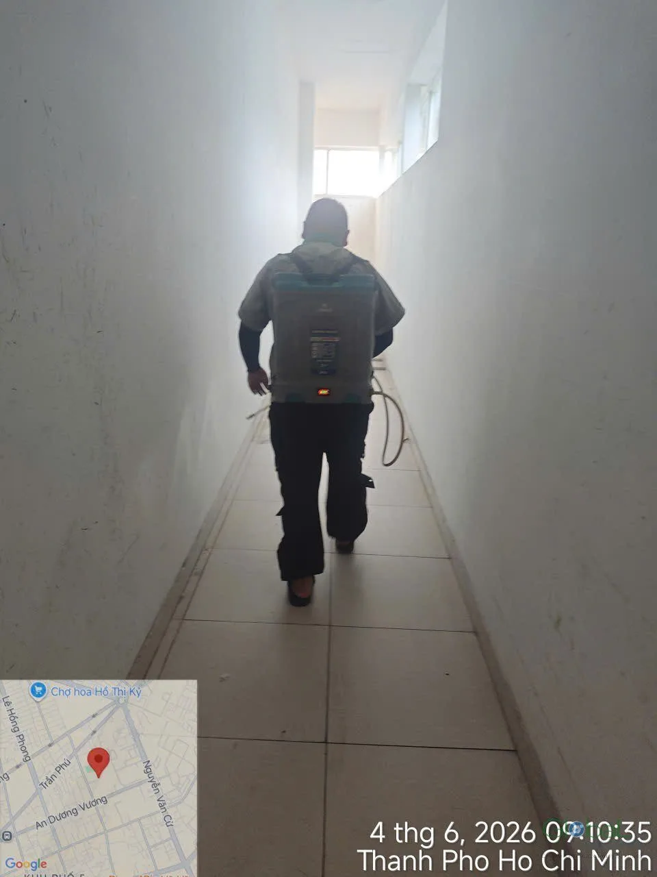 A technician cold-fogging an enclosed school corridor