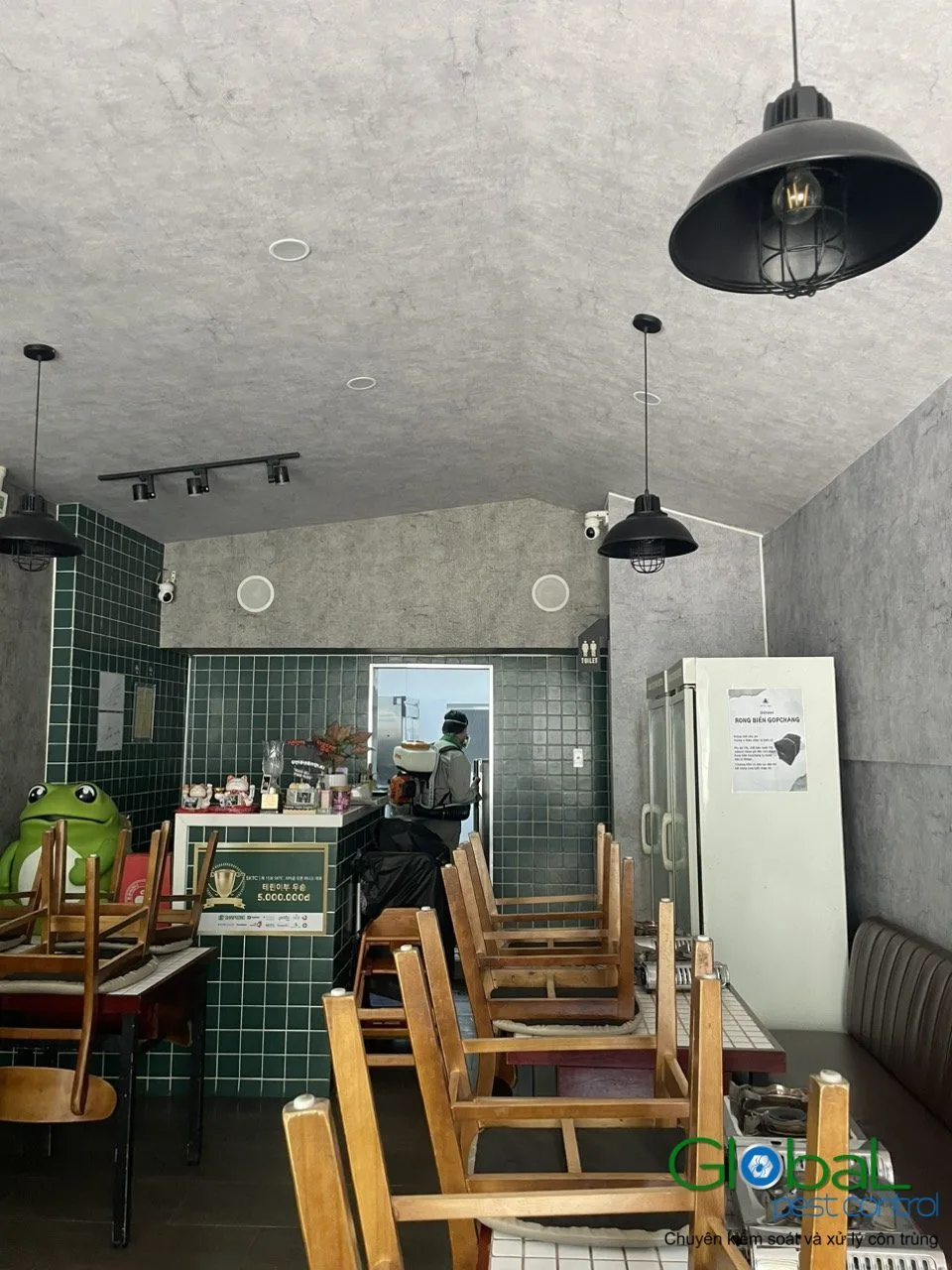 The open kitchen of an eatery with wooden furniture, treated for pests