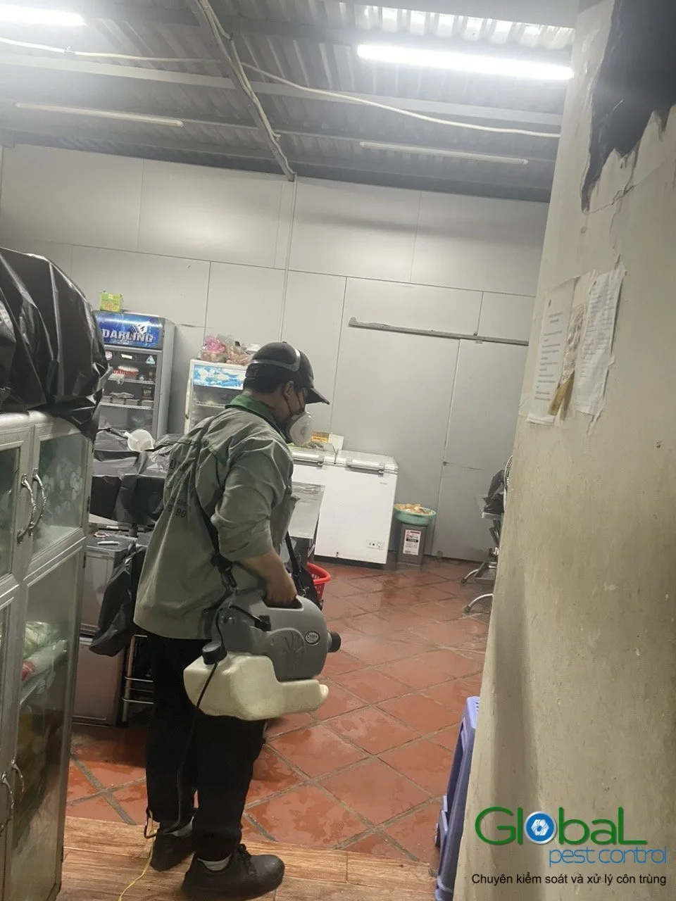 A technician cold-fogging a restaurant kitchen on a routine visit