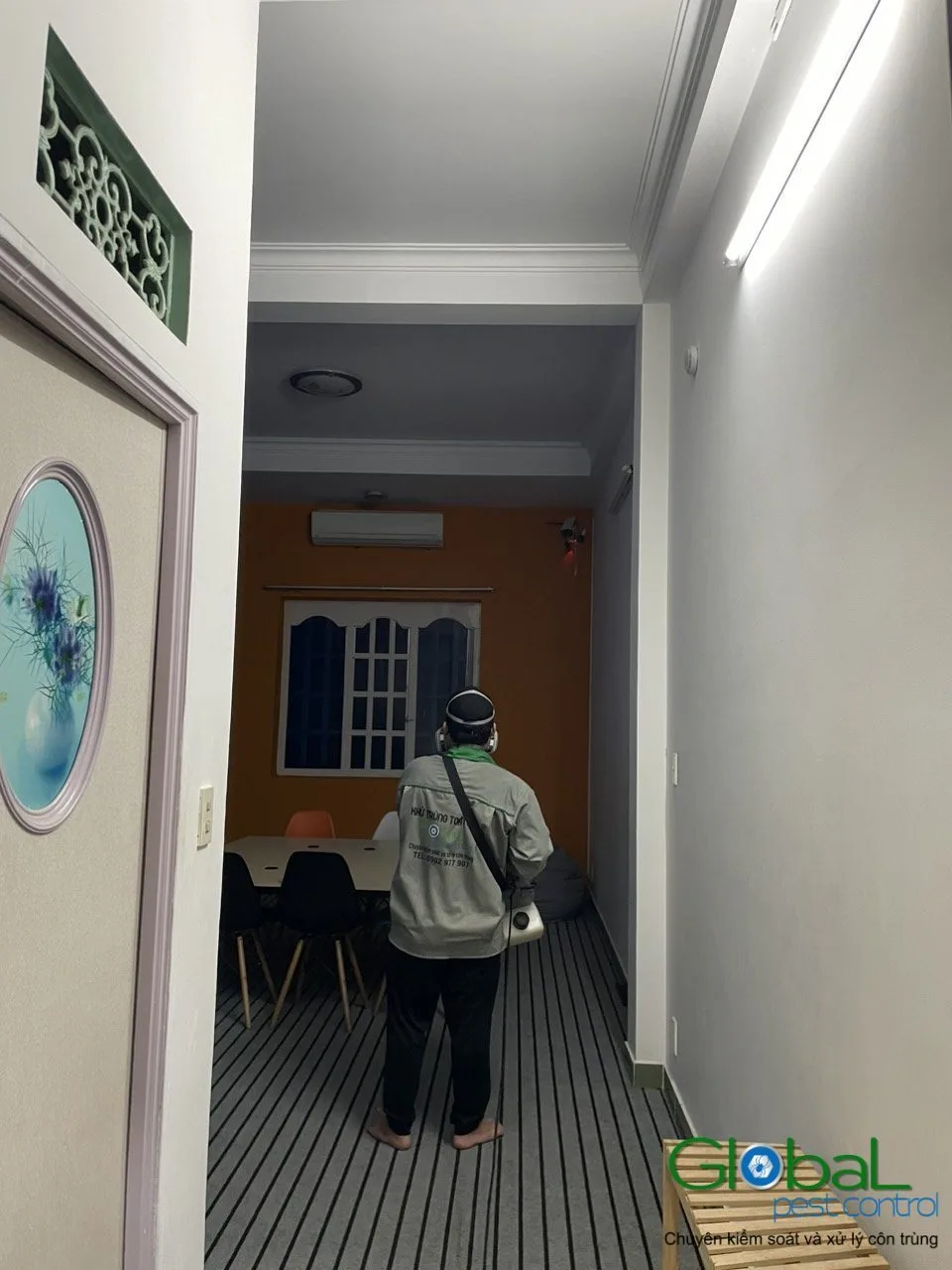 A technician treating an office corridor