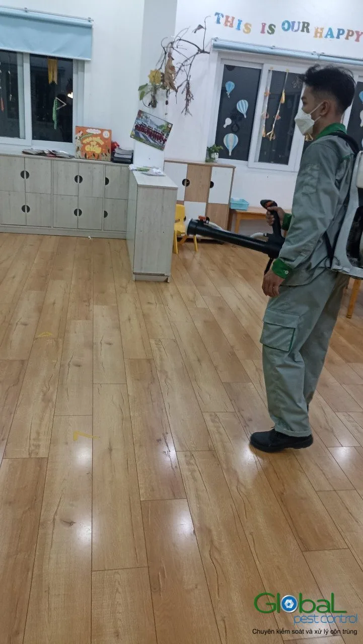 A technician cold-fogging a kindergarten classroom