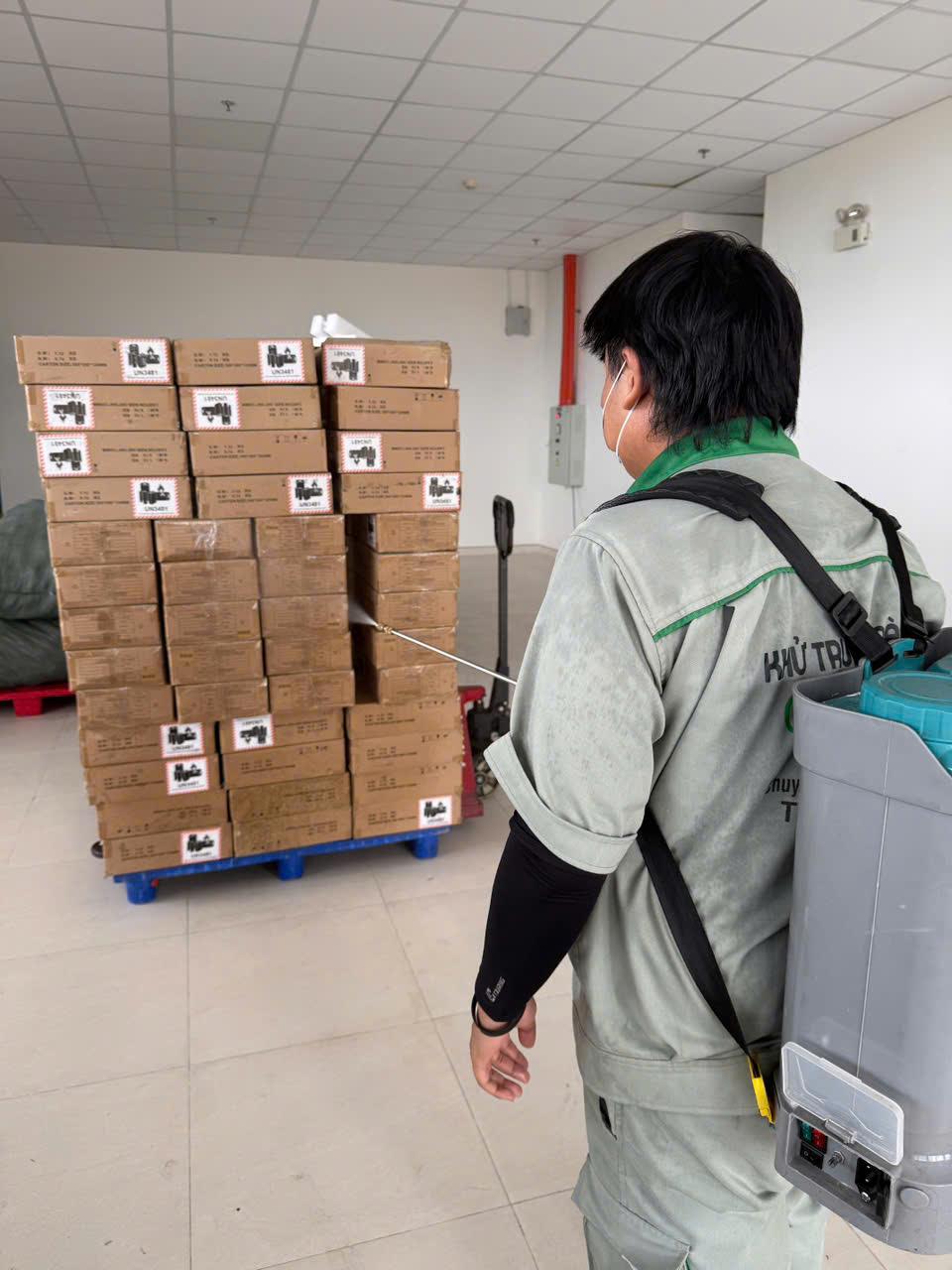 Two technicians working parallel aisles of pallets