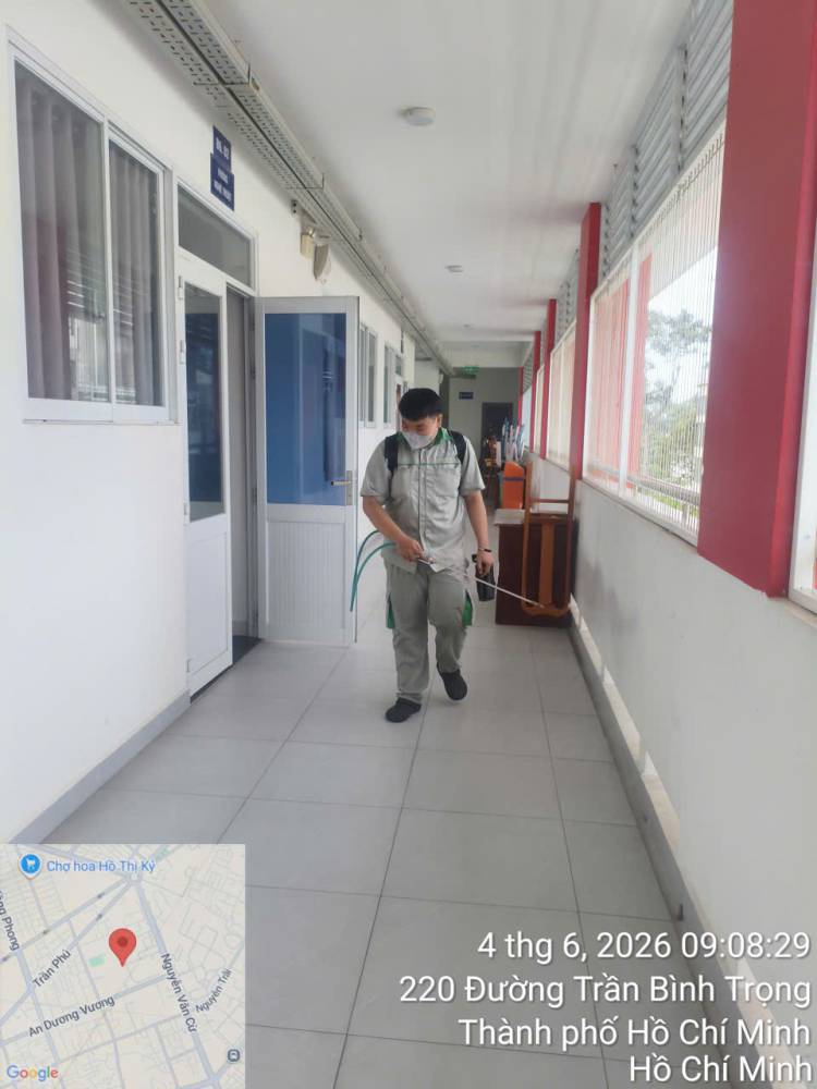 A technician treating a school corridor