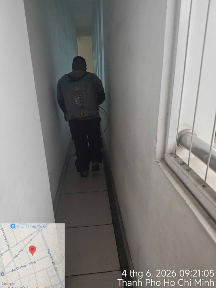 A technician treating corridors, stairs and storage areas inside a school