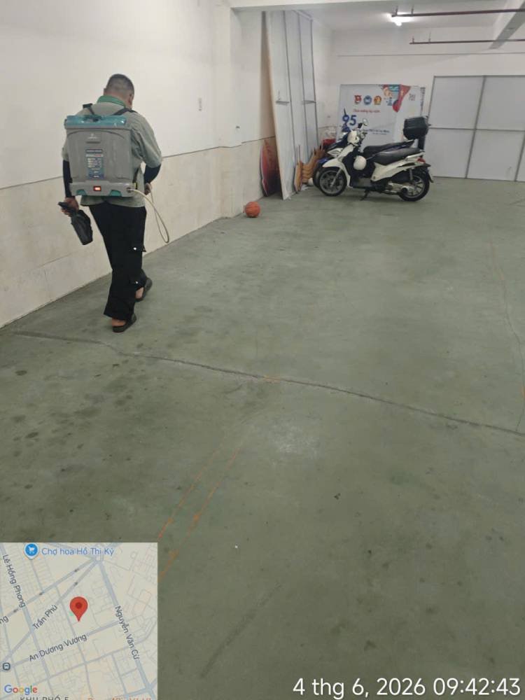 A technician treating corridors, stairs and storage areas inside a school
