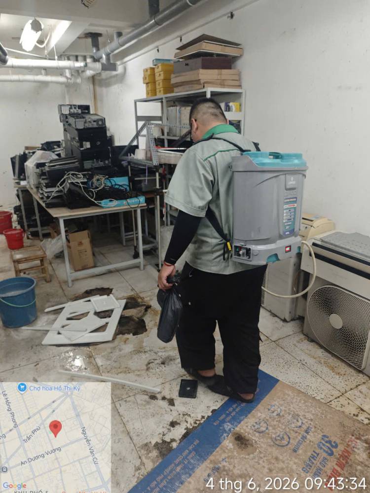 A technician treating corridors, stairs and storage areas inside a school