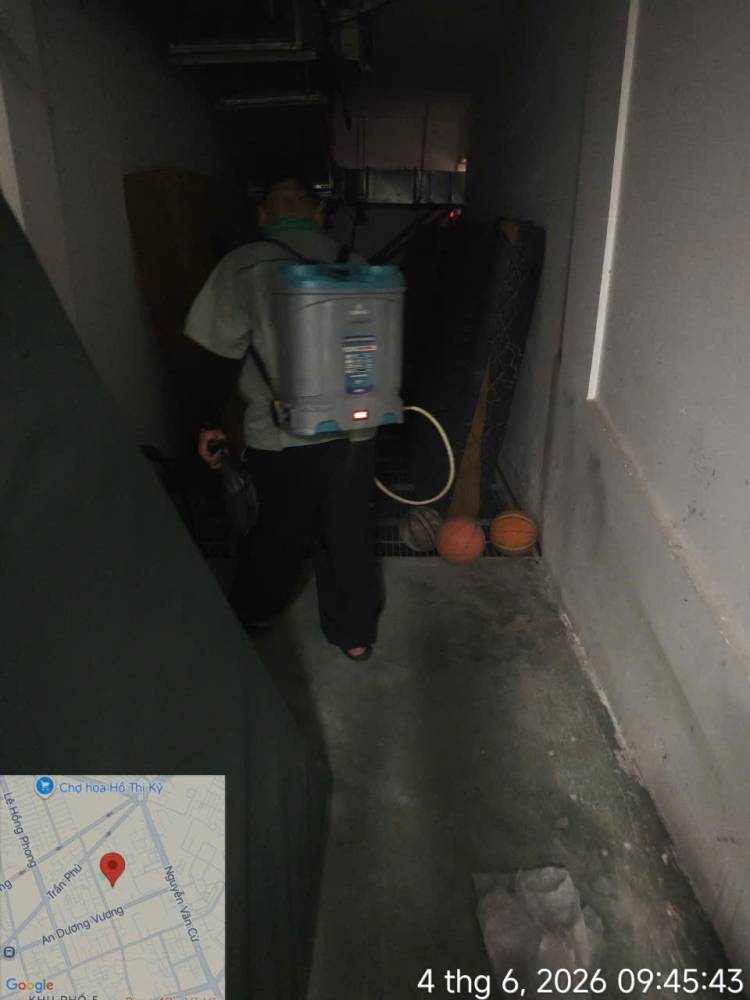 A technician treating corridors, stairs and storage areas inside a school