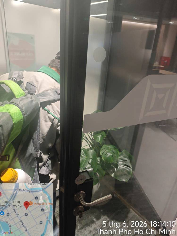 A technician treating indoor planters and pantry areas in an office