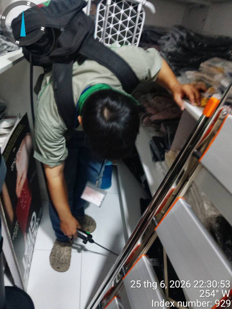 A technician preparing equipment beside a vehicle