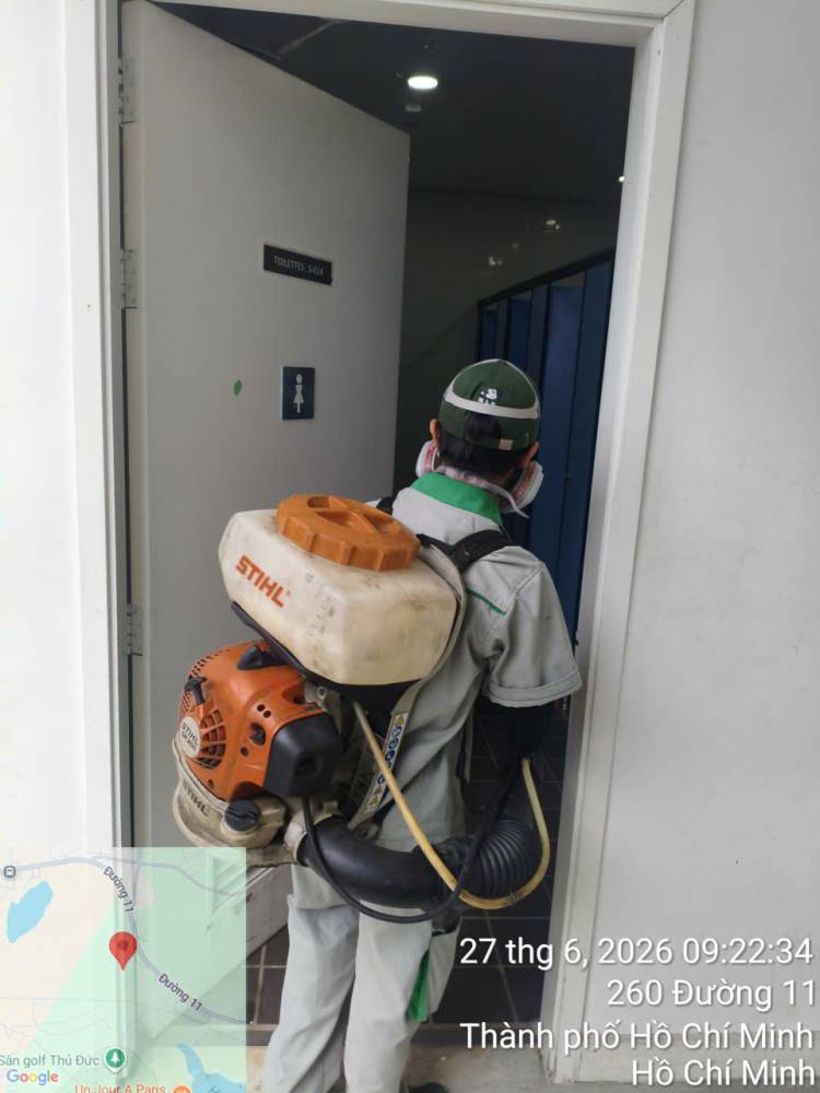 A technician treating classrooms and laboratory rooms