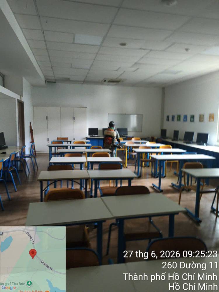 A technician treating classrooms and laboratory rooms